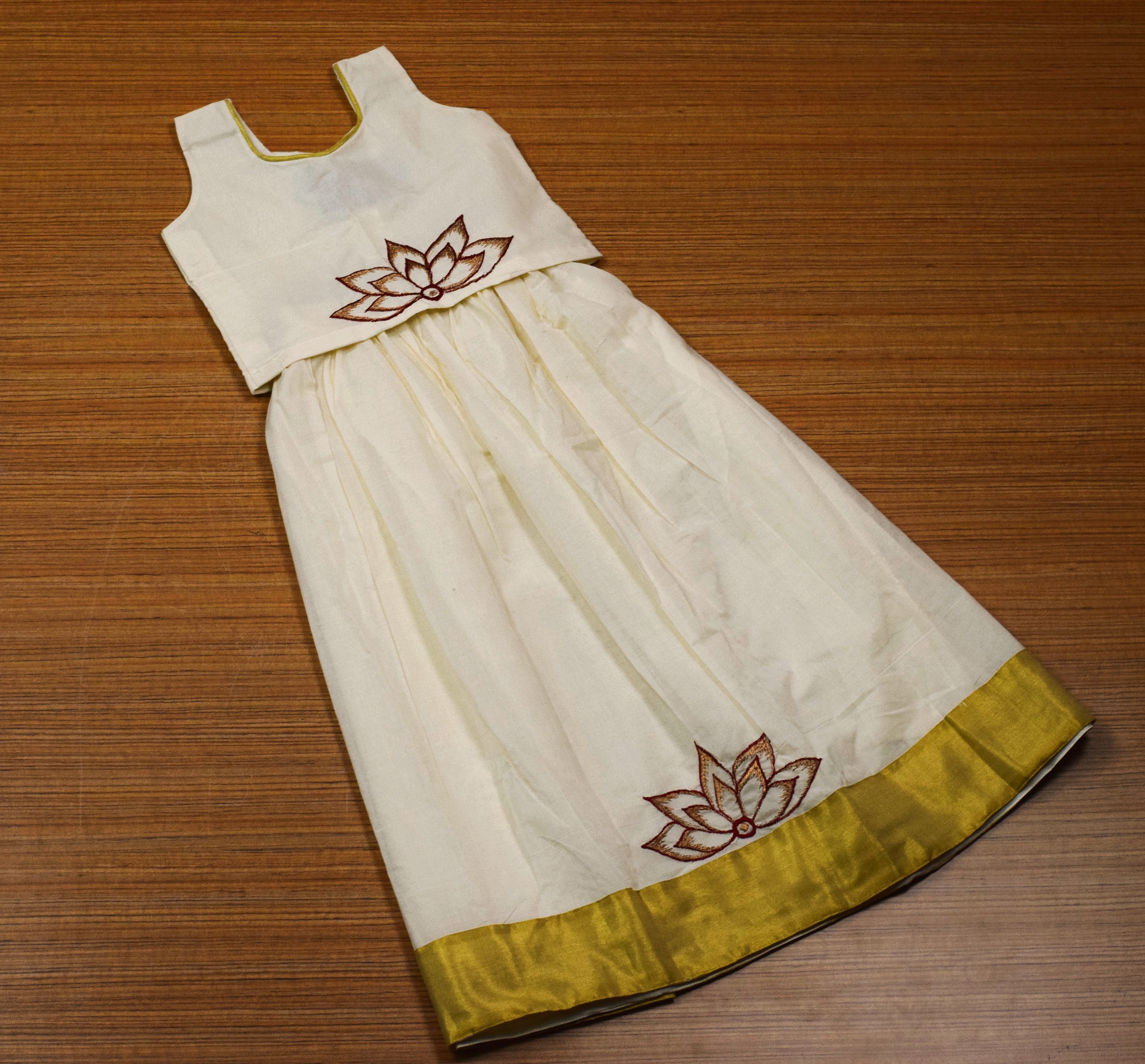 Girls Traditional Onam Skirt & Top Set – Off White Cotton Dress with Golden Kasavu Border & Lotus Embroidery