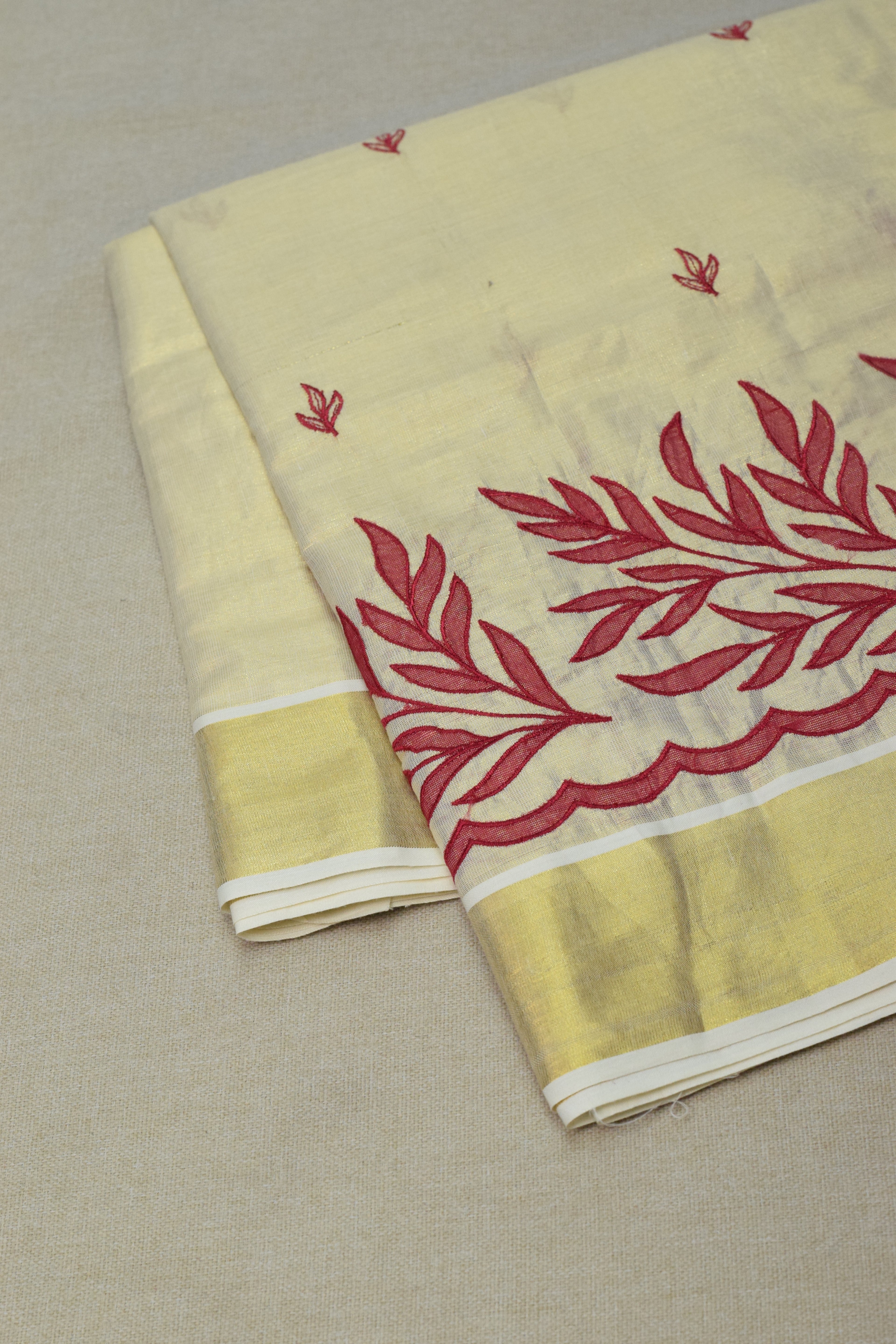 Kerala Tissue Saree with Maroon Floral Embroidery & Golden Border