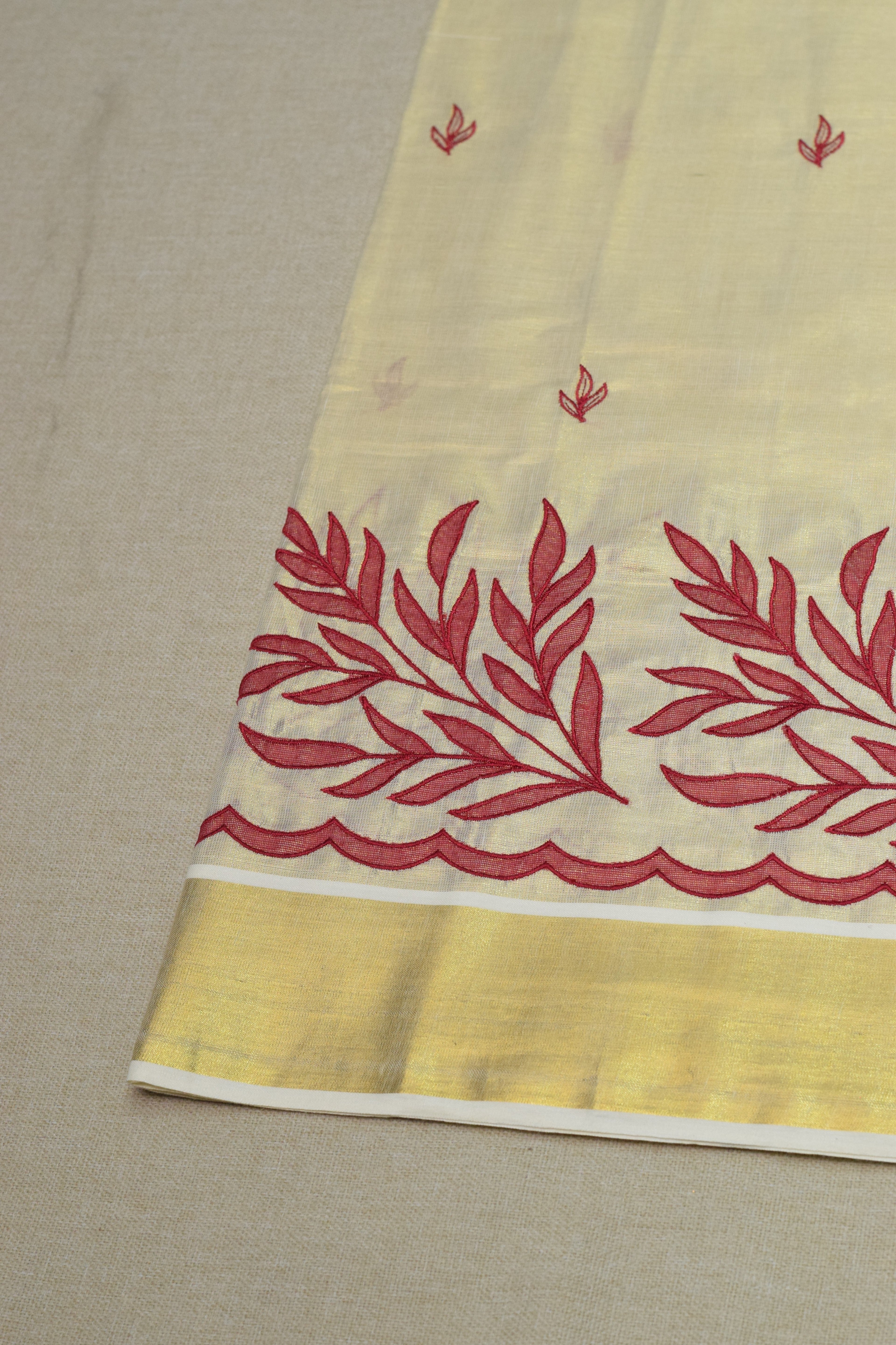 Kerala Tissue Saree with Maroon Floral Embroidery & Golden Border